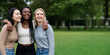 © SuperImages - Three Young Women Laughing Together in a Park, Displaying Friendship, Joy, Diversity, and Unity in a Natural Outdoor Setting