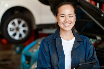 Poster - Portrait, mechanic and woman with tablet in auto repair shop, smile and internet for online schedule. Face, person and entrepreneur with tech in garage, car and vehicle maintenance with inspection