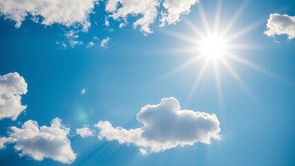 a vibrant summer sky with fluffy white clouds and a bright shining sun beams down on a clear blue da