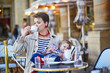 © Ekaterina Pokrovsky - Beautiful young mother and her adorable toddler daughter enjoying their time together in outdoor cafe in Paris, France.