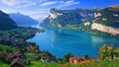 © creativeideh - Stunning alpine lake vista with charming villages nestled amongst rolling hills and majestic mountains.  Clear blue water reflecting a vibrant sky