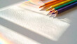 © EnelEva - Vibrant colored pencils arranged on textured white surface, casting soft shadows and reflecting light, create cheerful and artistic atmosphere