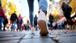 © Generative AI - A person walks on a cobblestone street in autumn, their white sneakers in focus, while the surrounding crowd blurs into a bokeh of fall colors and movement. : Generative AI