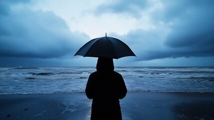 Aufkleber - Silhouette of a person with a black umbrella standing on a beach, facing a stormy sea under a dramatic, blue-toned sky. : Generative AI