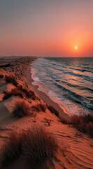 Poster - Sunset over a pristine beach, orange sand dunes meet turquoise ocean waves under a vibrant sky.  The sun dips below the horizon, casting a warm glow on the landscape.
