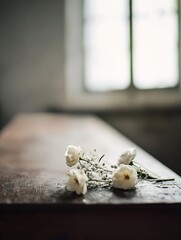 Aufkleber - Delicate white flowers rest on a rustic wooden surface, bathed in soft, natural light from a nearby window, creating a serene and peaceful atmosphere. : Generative AI