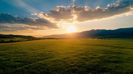 Poster - Serene sunset over vast green field, sun rays piercing through clouds, majestic mountain range silhouette in the background, idyllic landscape photography. : Generative AI