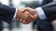 © Generative AI - Close-up shot of two businessmen shaking hands, signifying a successful business deal or partnership agreement.  The image focuses on the detail of the handshake against a blurred offi : Generative AI