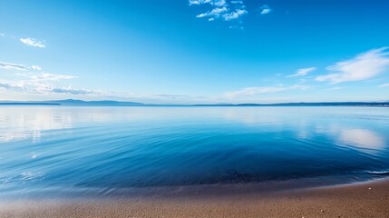 Poster - Serene coastal landscape featuring a tranquil blue ocean meeting a sandy shore under a vibrant, cloud-streaked sky, mountains in the distance. : Generative AI