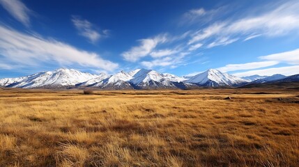 Aufkleber - Majestic snow-capped mountain range under a vibrant blue sky, overlooking a vast expanse of golden grassland.  A serene landscape photo ideal for travel, nature, and adventure themes. : Generative AI