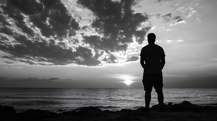 Fototapete - Silhouette of a man standing on a rocky shore, gazing at a dramatic sunset over a calm ocean, under a sky filled with dark, brooding clouds. : Generative AI