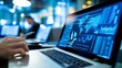 © Generative AI - Close-up of a laptop screen displaying global data analytics, charts, and graphs in a blue hue, with a person's hand holding a pen in the foreground, suggesting data analysis or busine : Generative AI