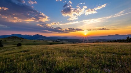Poster - Serene sunset over rolling hills and grassy plains, vibrant colors paint the sky as the sun dips below the horizon, casting a warm golden glow. : Generative AI