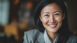 © 路加 石 - A smiling Asian woman in professional attire, radiating confidence and warmth.