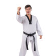 © suphaporn - Young Asian man in taekwondo uniform with black belt raising fist in confidence, smiling and standing isolated on a transparent background, concept martial arts, strength, discipline and self-defense