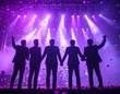 © Hafizoh - 7 man standing together on stage, facing a sea of shining lights purple from their fans