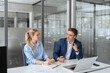 © Stock 4 You - Two partners, colleagues, team of professional finance specialist business people working together. Mature mentor senior leader man, young woman manager discussing project sitting at desk in office