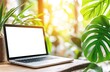 © photopixelstudio - Laptop computer on a wooden table, surrounded by lush greenery and sunlight.  A blank screen provides a neutral background