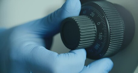 Wall Mural - close-up of biologist gloved hands using microscope in sterile laboratory. vibrant blue gloves highl