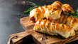 © hardvicore - Sausage rolls with rosemary on wooden board. Tasty food. Delicious snack.