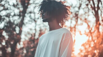 Poster - A person with curly hair standing near trees, perfect for travel or nature-themed designs