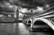© photopixelstudio - London Houses of Parliament, Big Ben, and a bridge under a dramatic sky