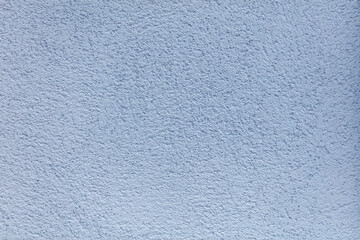 Wall Mural - A blue wall with a rough texture