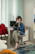 © ADDICTIVE STOCK - Young Boy Engaged in Mobile Gaming with Headphones On