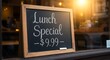 © Sabrina - A café or restaurant window with a chalkboard sign showing 'Lunch Special – $9.99'