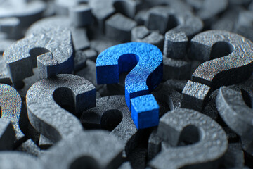Poster - Blue question mark among many gray ones, textured surface, symbolizing finding answers, unique solution, or standing out from the crowd