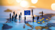 © sam richter - Tiny people stand holding European Union flag