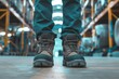 © Vorda Berge - Close up of safety working shoe on worker feet standing in factory