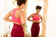 © Prostock-studio - Unhappy African American Woman Touching Fat Belly Standing Near Mirror, Gaining Kilograms And Not Losing Excess Weight Dieting At Home. Unsuccessful Slimming Concept. Selective Focus