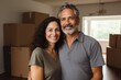 © Vorda Berge - portrait of a smiling middle age hispanic couple in empty home after moving in