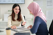 © snowing12 - Muslim Business Women Meeting Asian Partner Discussing Financial Data and Investment Strategy at Office Workplace for Islamic Finance