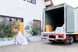 © Rakchanok - Delivery truck stop in front of new house full of packages and cardboard box and furniture prepared to send to customer, moving house services company, shipping small business entrepreneurship