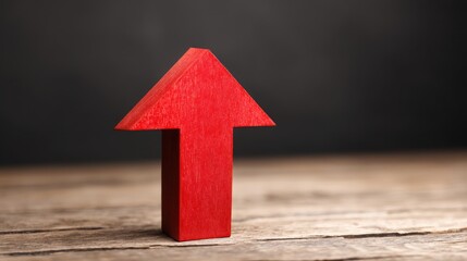 Poster - A striking red arrow positioned on a wooden table illustrating direction and momentum in a concept of motion