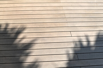 Poster - Wood plank floor shadow sunlight pattern outdoor texture abstract tropical create calm outdoor scene with sunlight casting tropical leaf shadows