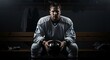 © Dmitry - Man athlete hockey player sitting on bench locker room holding helmet after intense training session, dedicated to hockey and sport concept.