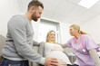© auremar - pregnant woman with her husband visiting the doctor in clinic