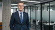 © Janitha - Confident Middle-Aged Businessman in Navy Suit, Modern Office Portrait