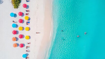 Poster - Aerial perspective revealing sunbathing tourists relaxing under colorful umbrellas, swimming in crystal clear turquoise waters along pristine white sandy coastline