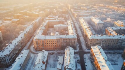 Poster - Warm sunlight bathes snow covered residential buildings in a tranquil urban scene, capturing the serene beauty of a winter morning in the city, with streets and rooftops blanketed in white