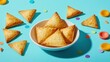 © andi - Crispy triangular pastries in a bowl