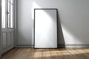 Poster - blank black frame leaning against a wall in a room with a wooden floor and door, illuminated by sunl