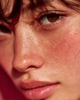 © Julia - Close-up side profile of a woman's face, emphasizing rosy cheeks and nose with fine lines