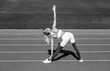 © Yevhen - Healthy woman doing exercise. Sports exercises and stretching in the stadium. Black and white