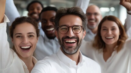 Fototapete - A group of happy Indian business professionals celebrates a recent success in a contemporary office. Their smiles and raised hands convey a sense of teamwork and enthusiasm