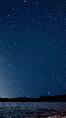 Wall Mural - sunrise over the sea with gentle waves and fading stars in a peaceful, dreamy atmosphere