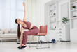 © New Africa - Beautiful woman stretching on chair at home, space for text